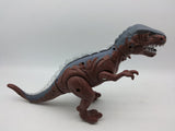 Na fotografiji se vidi dinosaurus T-Rex igračka.